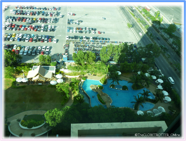 A VIEW OF THE POOL AREA FROM A ROOM.