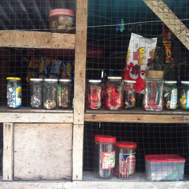 A small sari-sari store’s window (bottom left) for receiving payments.