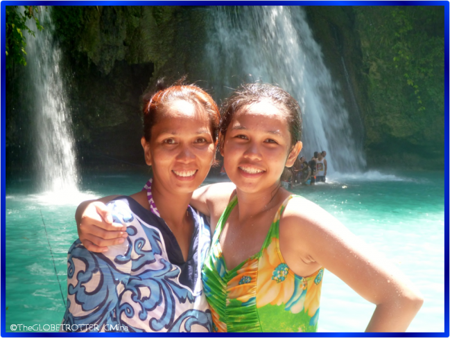 My mom and I with the background of the waterfalls in the lowest layer of Kawasan Falls.
