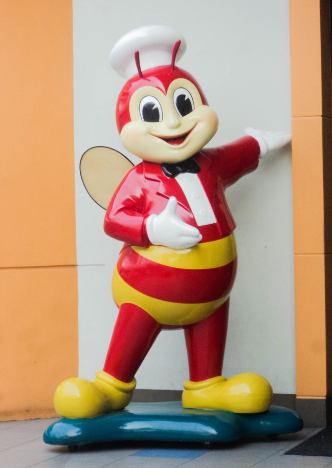 Jollibee Figurine, standing in front of the store’s entrance.