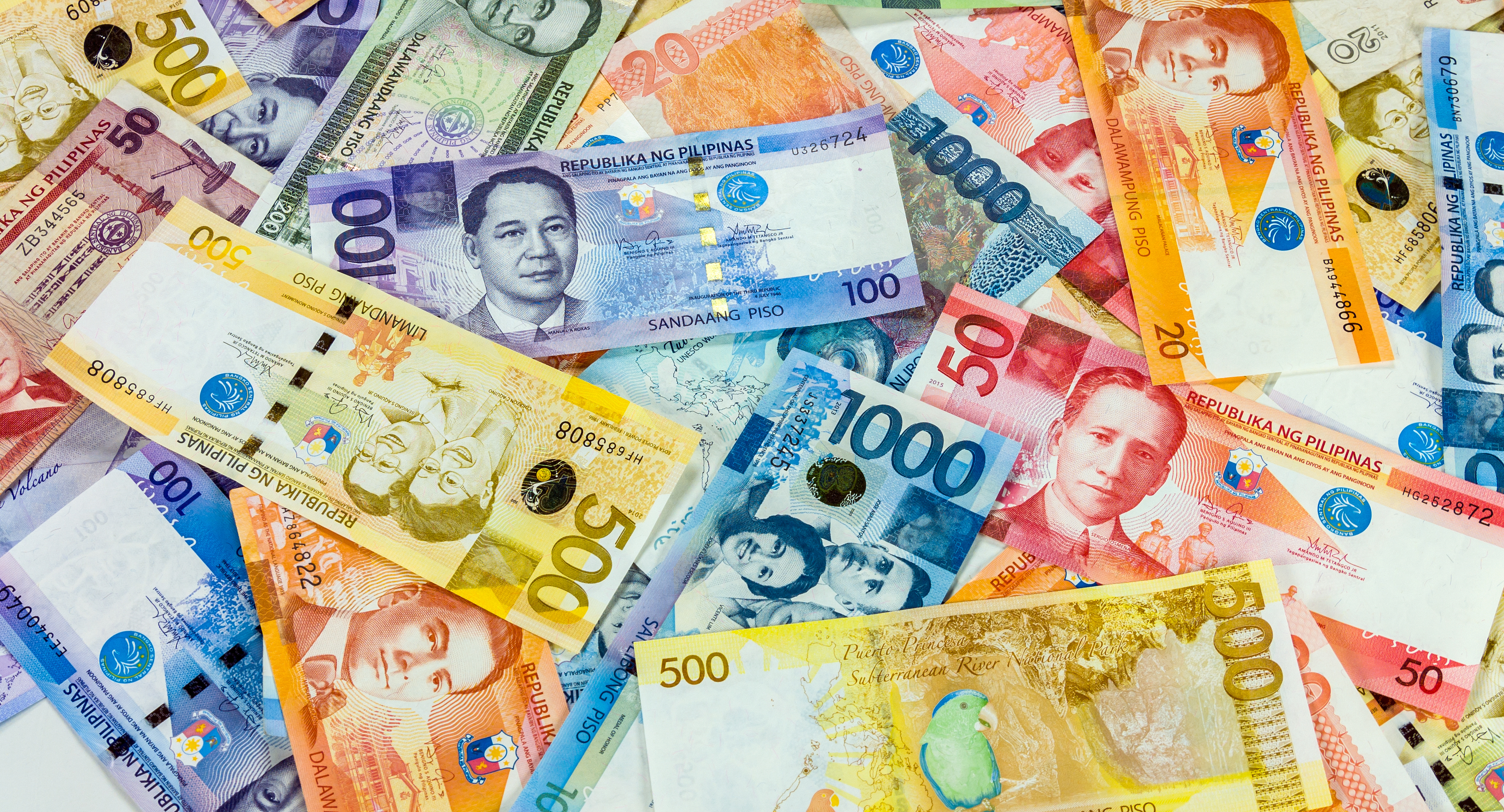 Colorful background of Philippines currency banknotes close up view.