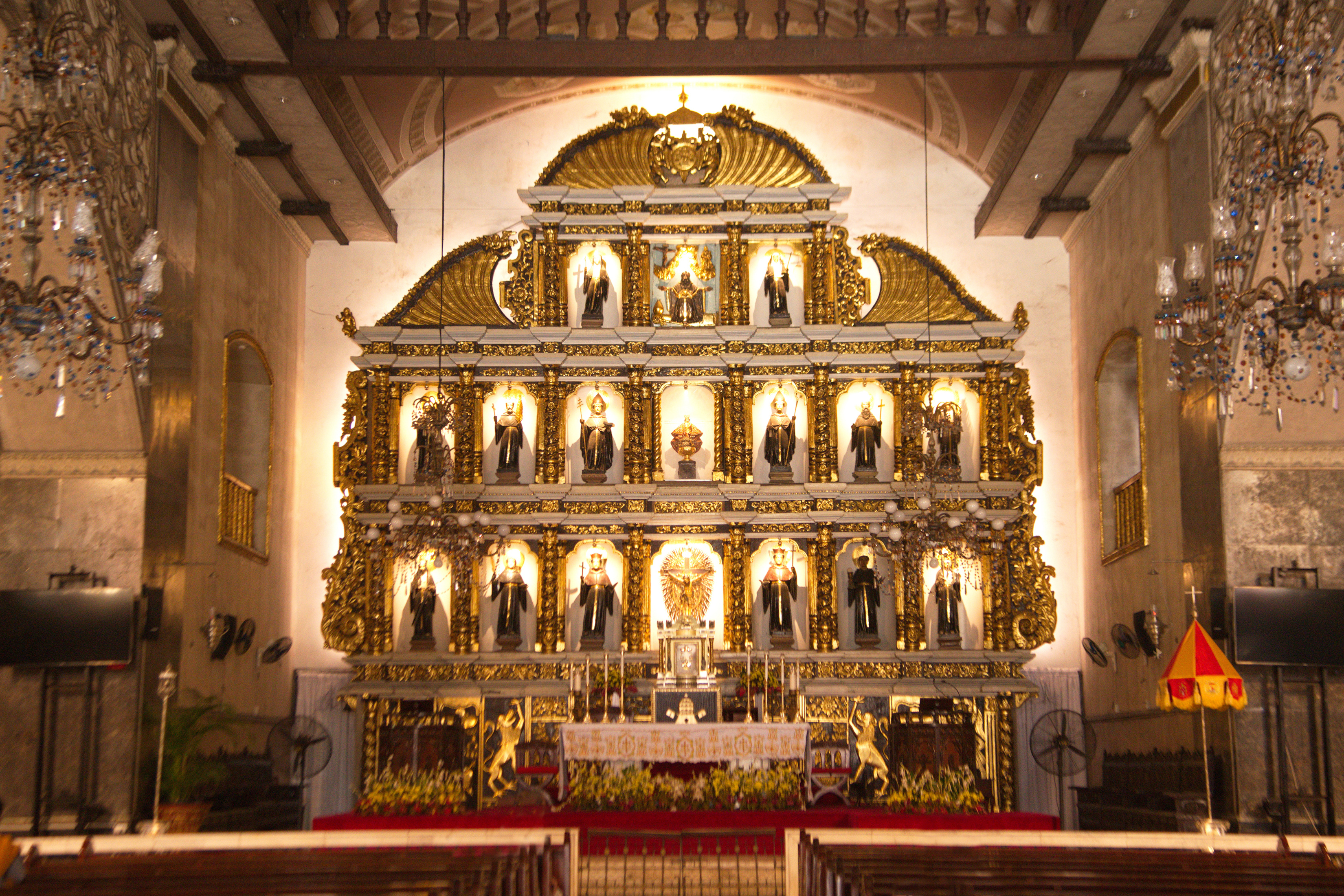 Jesus Christ Crucifixion on Cross and Saint Statues on altar at Basilica Minore del Santo Nino, the oldest church in the Philippines. Built in 1565 by Spanish colonists.